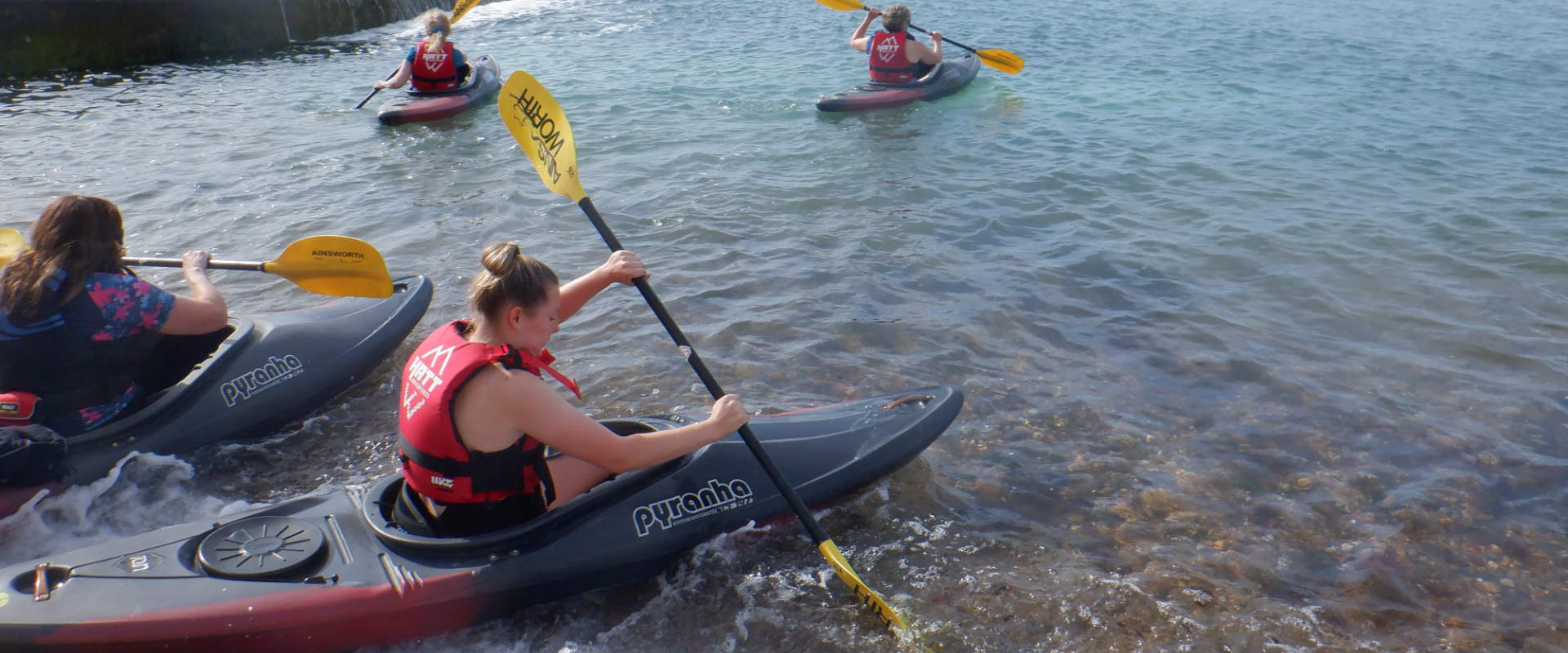 image shows four women in the watersports club going for a paddle off brighton marina